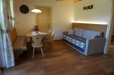 a small room with a bed and a dining table at Niederhaushof in Santa Valburga St. Walburg