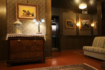 a living room with a dresser and a couch at Hotel Centrale in Alleghe