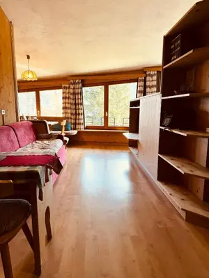 a living room with a couch and a table at Il Cirmolo delle Saline in Falcade