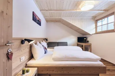 a bedroom with a large bed in a room at Huberhof in San Lorenzo di Sebato