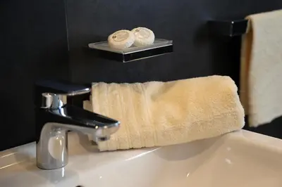 a bathroom sink with a towel on top of it at Appartamenti Te Paisc in La Villa