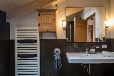 a bathroom with a sink and a mirror at Appartamenti Te Paisc in La Villa