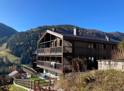 a large house on top of a hill at Florisa Mountain Penthouse in San Vigilio Di Marebbe