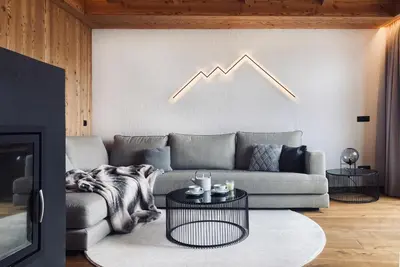 a living room with a couch and a graph on the wall at Florisa Mountain Penthouse in San Vigilio Di Marebbe