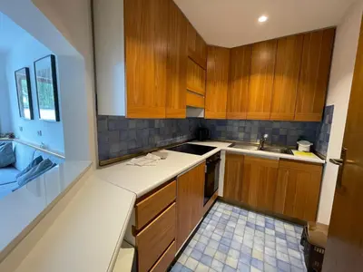 a kitchen with wooden cabinets and a sink at Les Corcelles in San Vigilio Di Marebbe