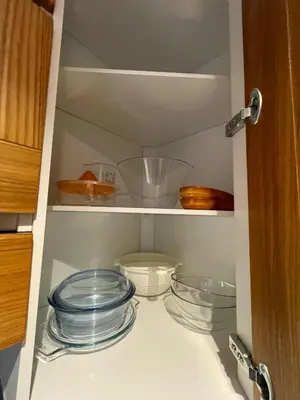 a cabinet with plates and bowls in it at Les Corcelles in San Vigilio Di Marebbe
