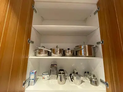 a kitchen with two pots and pans on a shelf at Les Corcelles in San Vigilio Di Marebbe