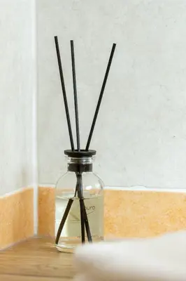 a glass vase with sticks in it on a table at Apartment Sabrina in Santa Cristina in Val Gardena
