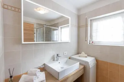 a bathroom with a sink and a mirror at Apartment Sabrina in Santa Cristina in Val Gardena