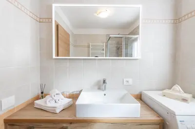 a bathroom with a sink and a mirror at Apartment Sabrina in Santa Cristina in Val Gardena