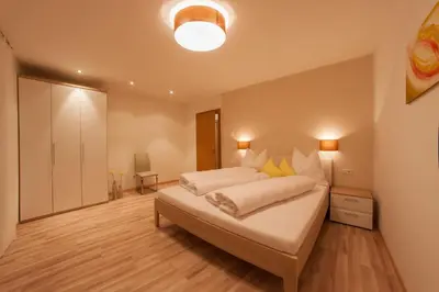 a bedroom with a large bed in a room at Appartements Verdinserhöhe in Schenna