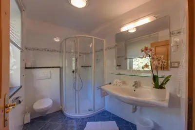 a bathroom with a sink and a shower and a toilet at Appartements Verdinserhöhe in Schenna