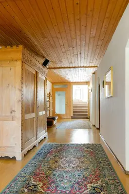 a large room with a rug on a wooden ceiling at Privatzimmervermietung Messner in Rifiano