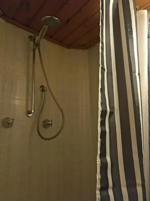 a shower with a shower head in a bathroom at Privatzimmervermietung Messner in Rifiano