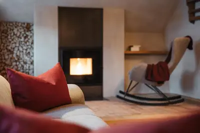 a living room with a couch and a fireplace at Lüch Colz in Badia