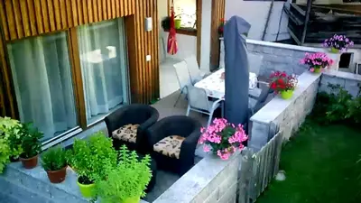 a patio with plants and a table and chairs at Appartement Alois in Bressanone
