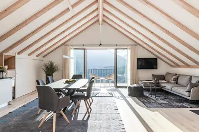 a living room with a table and chairs and a couch at Romy & Johannes Guesthouse in Schenna