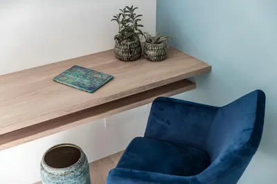 a blue chair sitting next to a wooden shelf at Romy & Johannes Guesthouse in Schenna