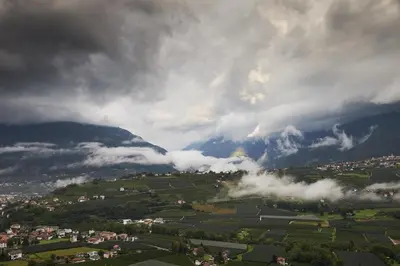 a view of a valley with clouds and mountains at Romy & Johannes Guesthouse in Schenna