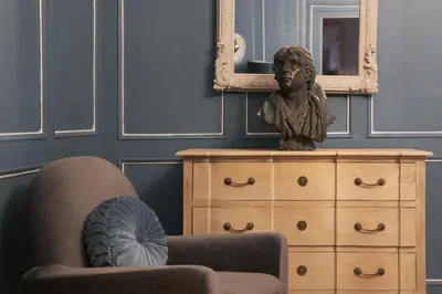 a statue of a bust sitting on a dresser in a room at La Cles Deluxe Suites in Cles