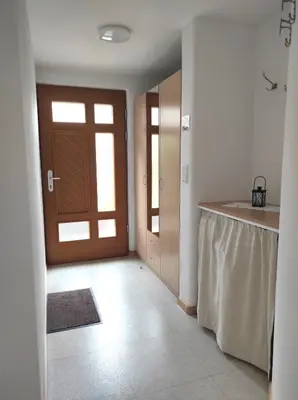 a kitchen with a door and a counter with a table at Ferienwohnungen Pircher in Rablà