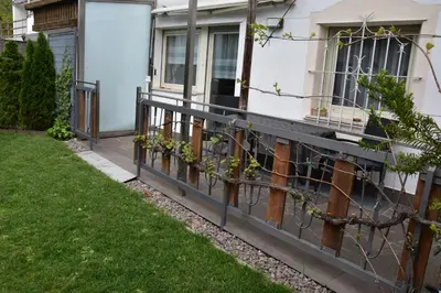 a fence in front of a house with plants at Ferienwohnungen Pircher in Rablà