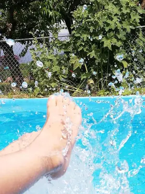 a persons foot in the water in a swimming pool at Ansitz Grustdorf in Appiano sulla Strada del Vino