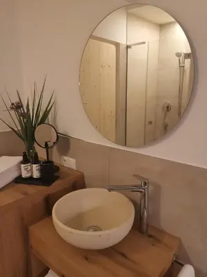 a bathroom with a sink and a mirror at Ansitz Grustdorf in Appiano sulla Strada del Vino