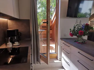 a kitchen with a view of a door to a patio at Ansitz Grustdorf in Appiano sulla Strada del Vino