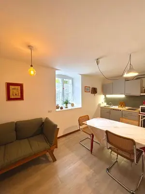 a kitchen with a table and chairs in a room at Cozy Apartment in a Historic Villa in Merano