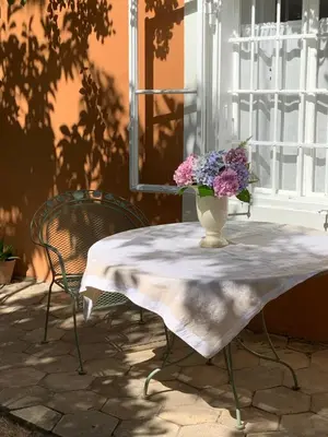 a small kitchen with a table and a dining room at Cozy Apartment in a Historic Villa in Merano