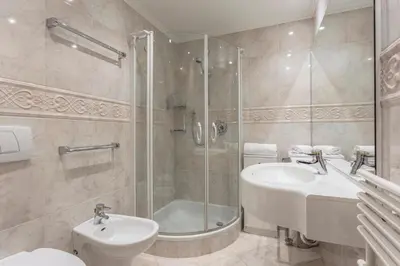 a bathroom with a shower and a sink and a toilet at Residence Castel in Ortisei