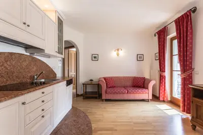a kitchen with a red couch in a room at Residence Castel in Ortisei