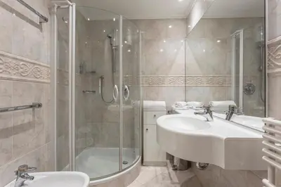a bathroom with two sinks and a shower at Residence Castel in Ortisei