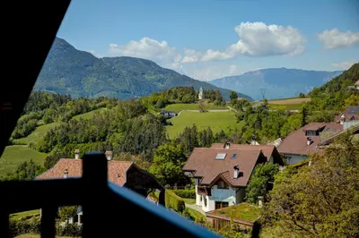 a view of a house in a valley with mountains at Gasthof Wunder in Auna di Sotto