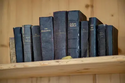 a row of books sitting on a shelf at Gasthof Wunder in Auna di Sotto