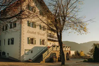 a building with a staircase in front of it at Gasthof Wunder in Auna di Sotto
