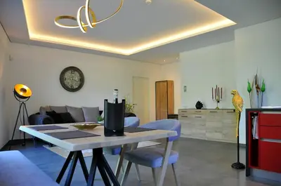 a living room with a table and a couch at Ruhige Ferienwohnung mit Garten und Garage in Privatvilla in Marlengo