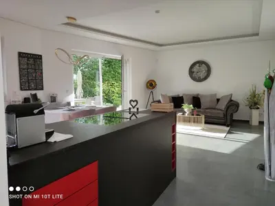 a living room with a counter and a living room with a couch at Ruhige Ferienwohnung mit Garten und Garage in Privatvilla in Marlengo