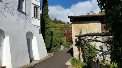 a side view of a house and a street at Ruhige Ferienwohnung mit Garten und Garage in Privatvilla in Marlengo