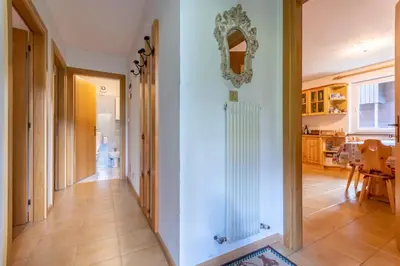 a hallway of a home with a mirror on the wall at Residence Sas de le Undesc in Soraga