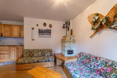 a living room with a couch and a table at Residence Sas de le Undesc in Soraga