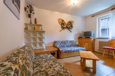 a living room with a couch and a chair at Residence Sas de le Undesc in Soraga