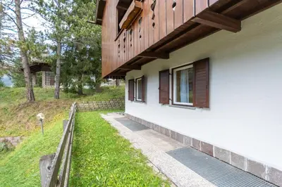 a building with a fence next to a yard at Residence Sas de le Undesc in Soraga