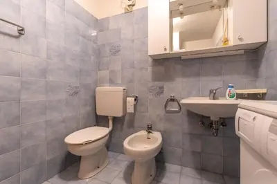 a bathroom with a toilet and a sink at Residence Sas de le Undesc in Soraga
