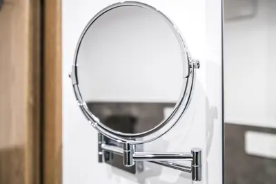 a round mirror hanging on a door at Laube35 Central City Apartments in Vipiteno