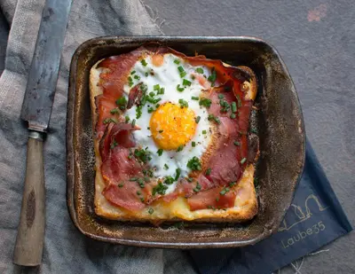 a pan of food with an egg on top at Laube35 Central City Apartments in Vipiteno