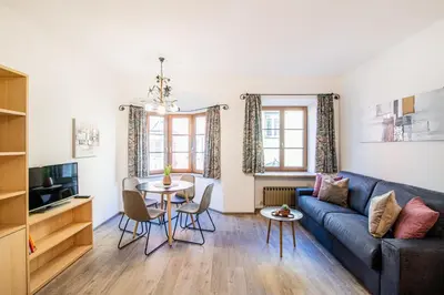 a living room with a couch and a table at Laube35 Central City Apartments in Vipiteno