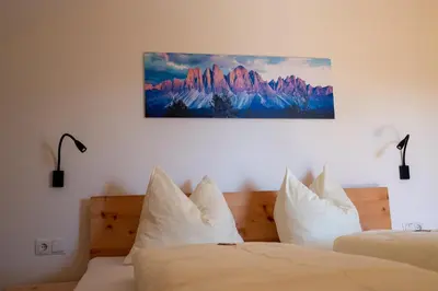 a bedroom with a large bed and a dresser at Apartments Kaserott in Villnoss