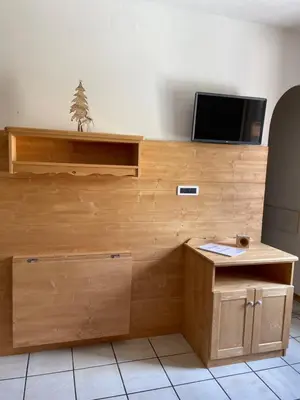 a bedroom with a wooden bunk bed with two beds at CIASA SORES in Moena